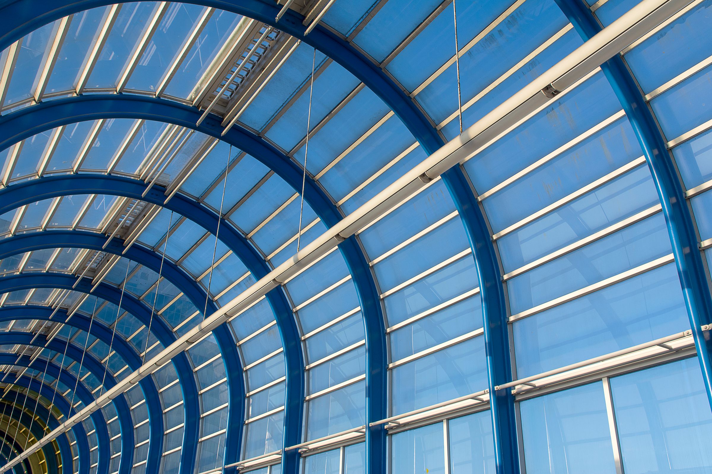 Repeating blue steel arches and glass panels at Zoetermeer station; illustrative architecture, not an Avantti project